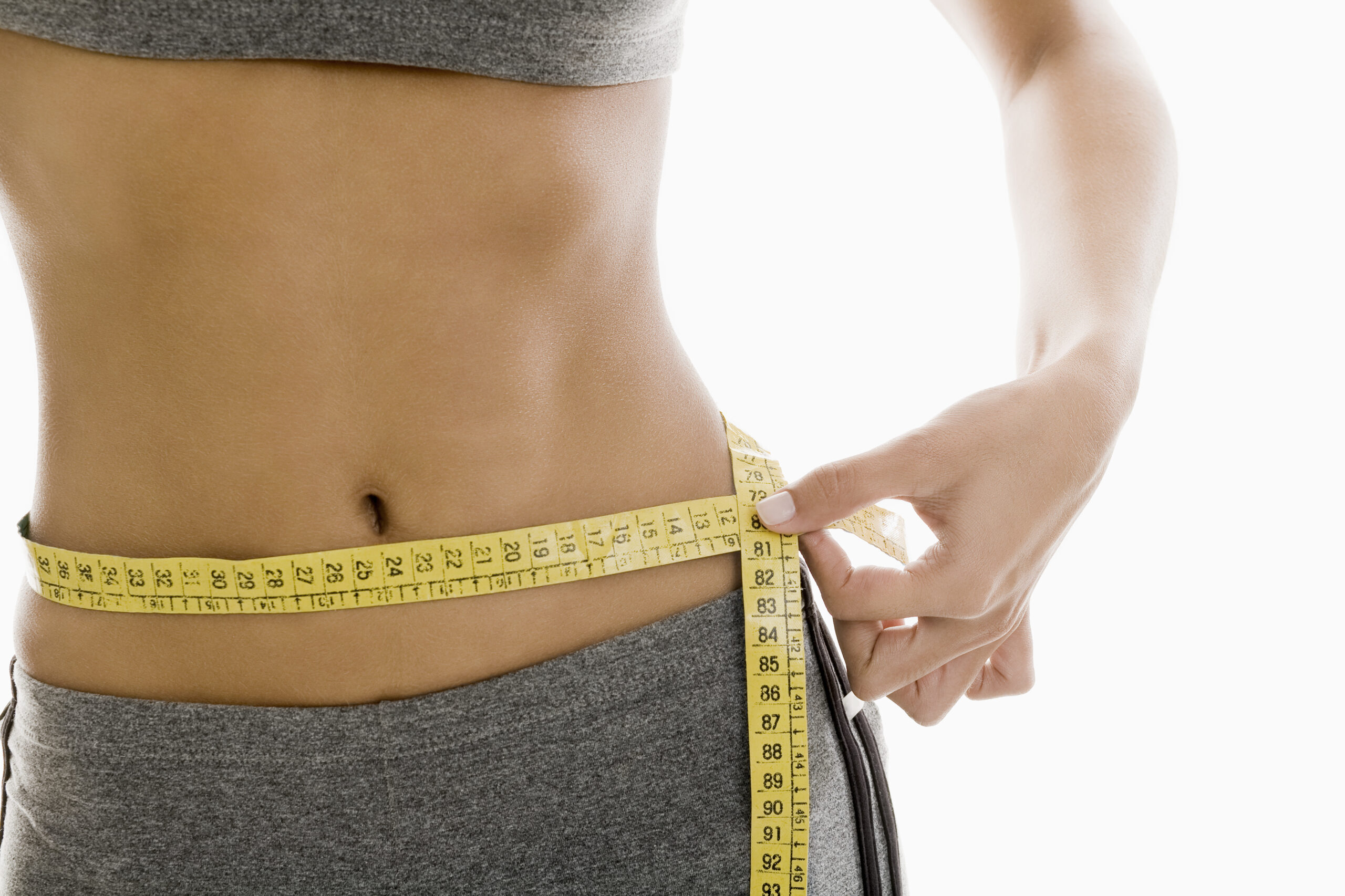woman-measuring-waist-using-tape-measure-mid-section