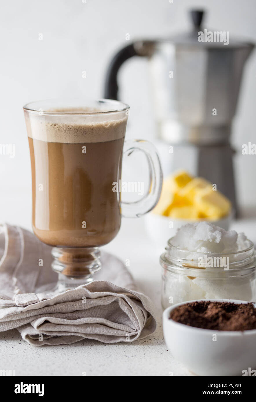 bulletproof-coffee-ketogenic-keto-diet-coffe-blended-with-coconut-oil-and-butter-cup-of-bulletproof-coffee-and-ingredients-on-white-background-pcjp91-6066517