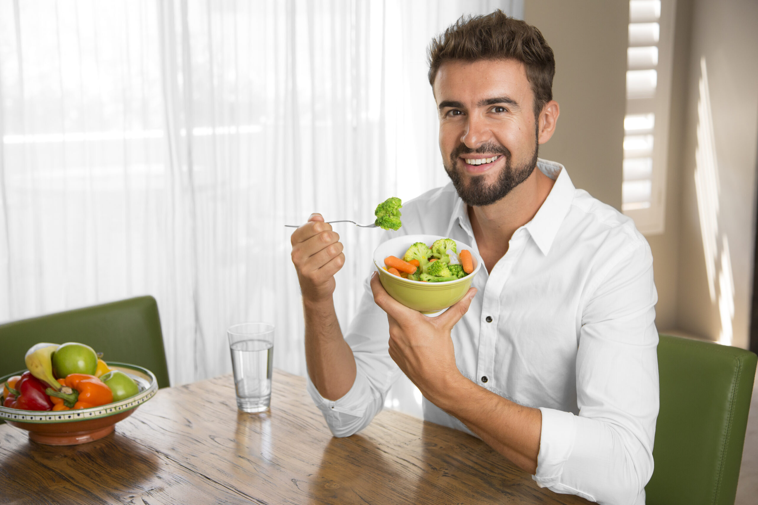 person-drinking-water-and-eating-vegetables