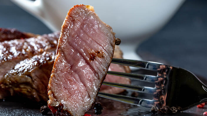 close-up-of-a-piece-of-juicy-steak-on-a-fork