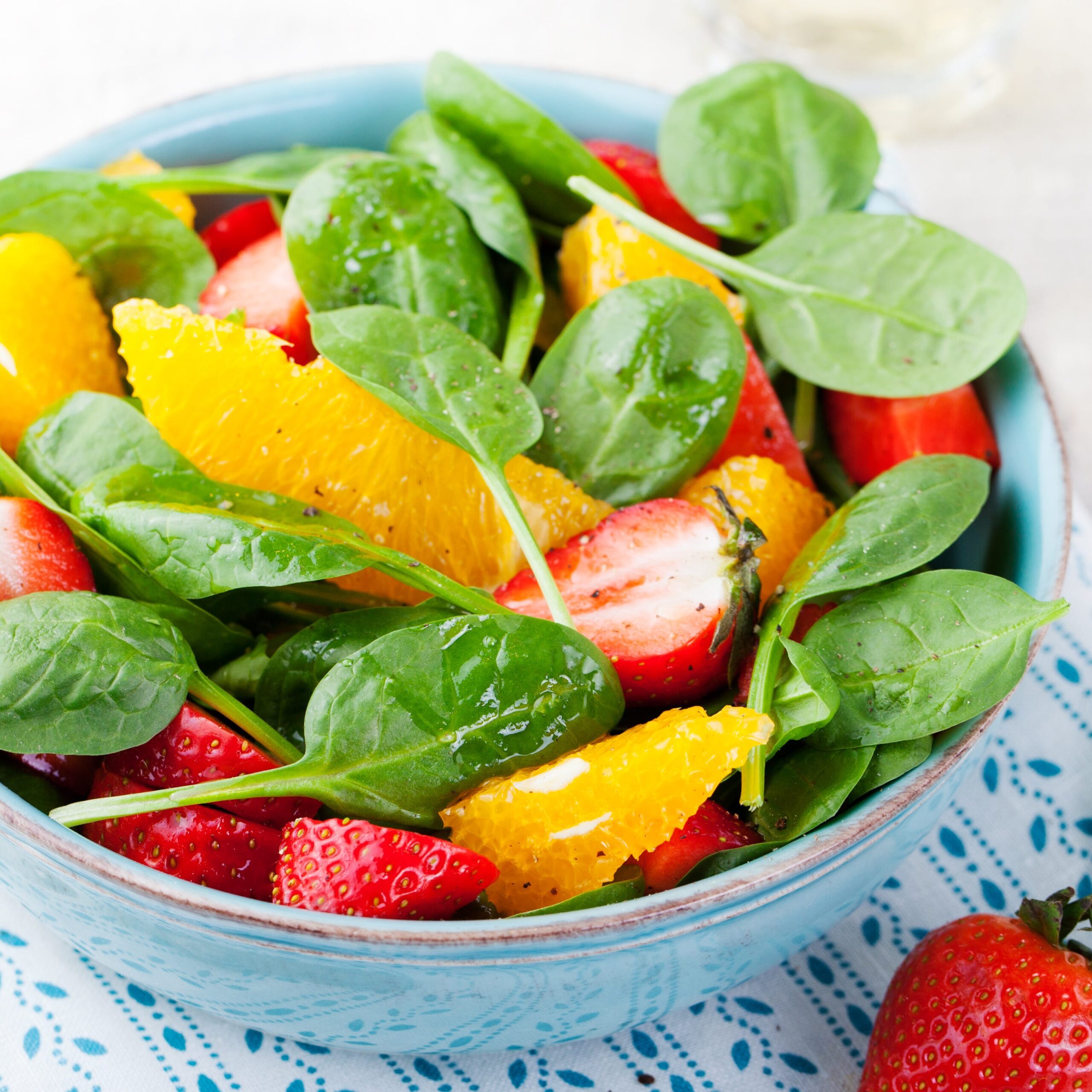 fresh-salad-with-strawberry-orange-and-spinach-royalty-free-image-510794204-1553031286-4798841