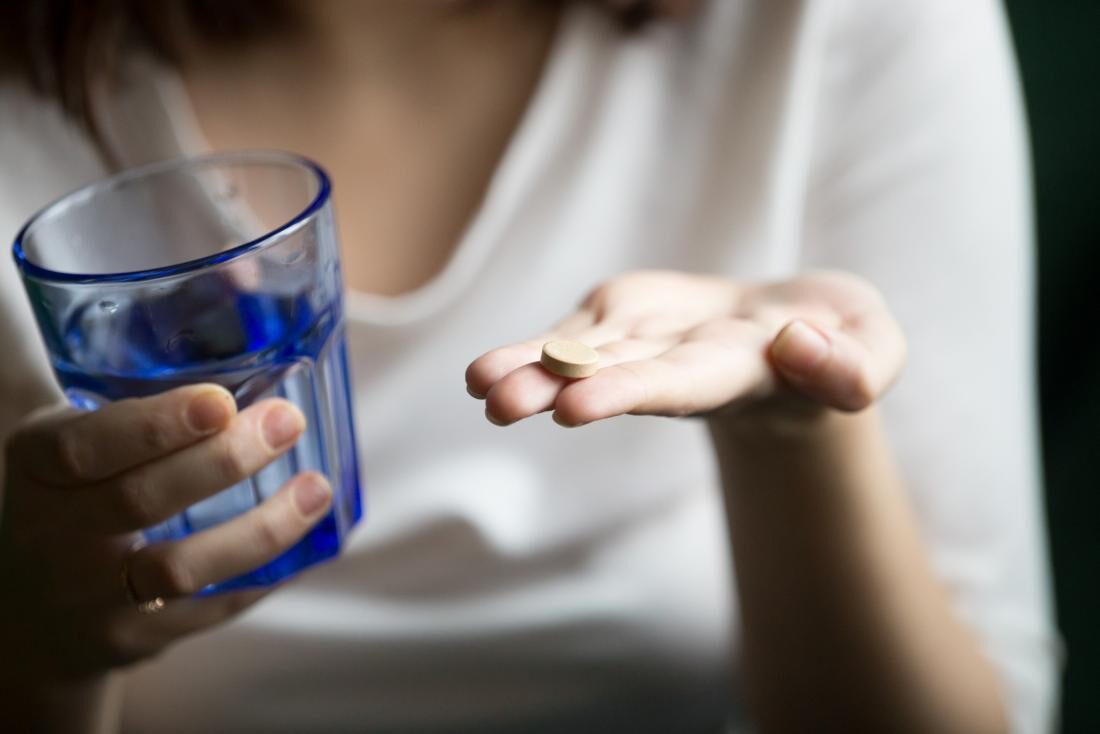 person-holding-antidepressant-and-a-glass-of-water-4672208