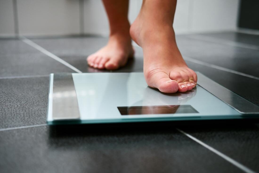 person-stepping-on-weighing-scales-2925264